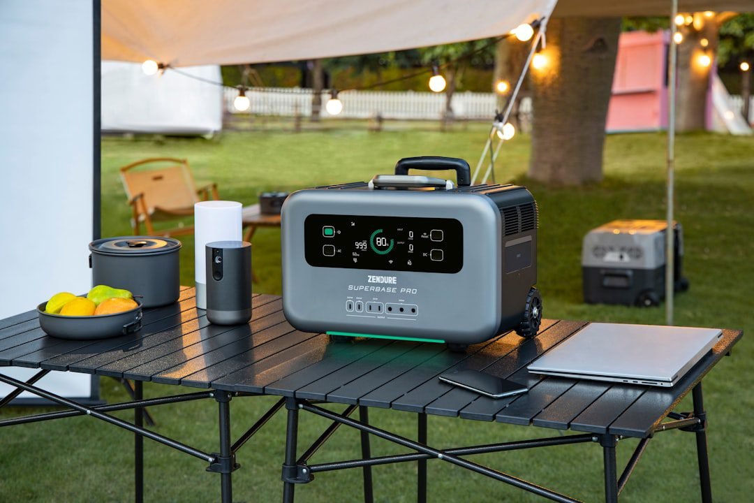 Portable power station set up outdoors near camping gear