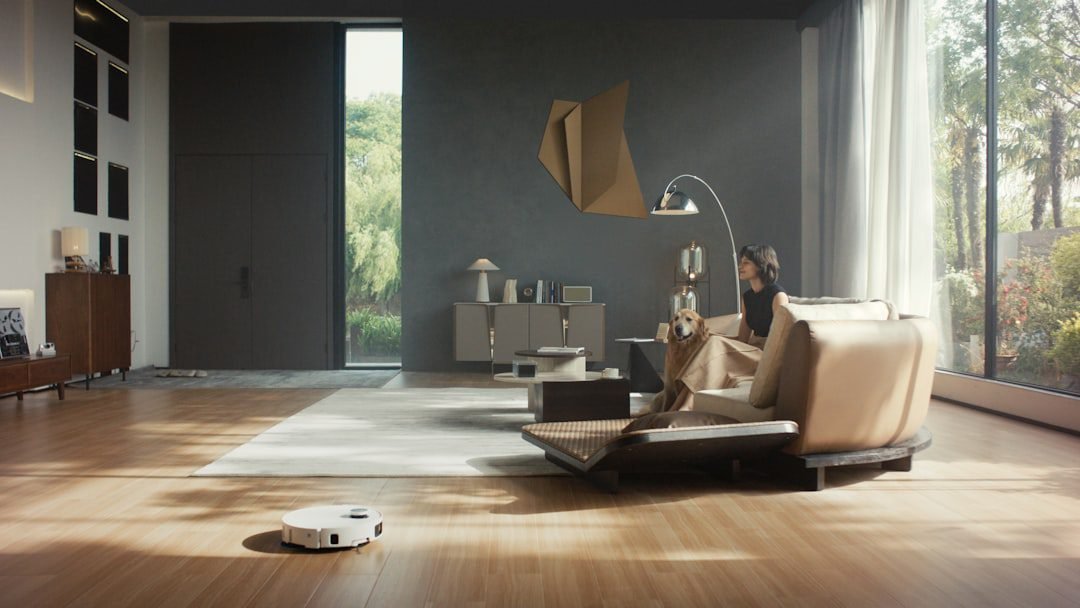 Robot vacuum cleaning a hardwood floor in a living room