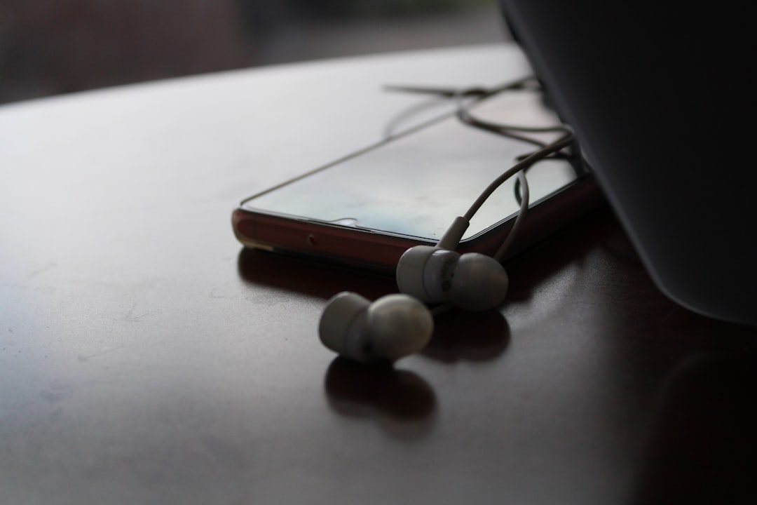Wired earbuds with a USB-C connector next to a smartphone