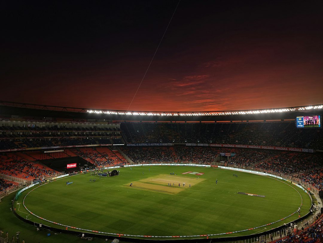 Cricket stadium with a green pitch under an evening sky, illustrating the Asian Games 2026 men's cricket final
