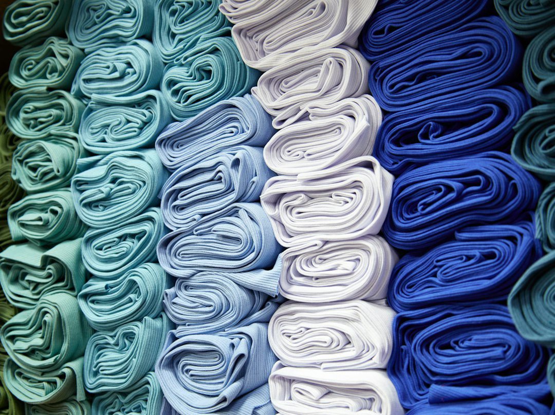 Stack of folded cotton fabric illustrating how fabric weight and thickness are judged